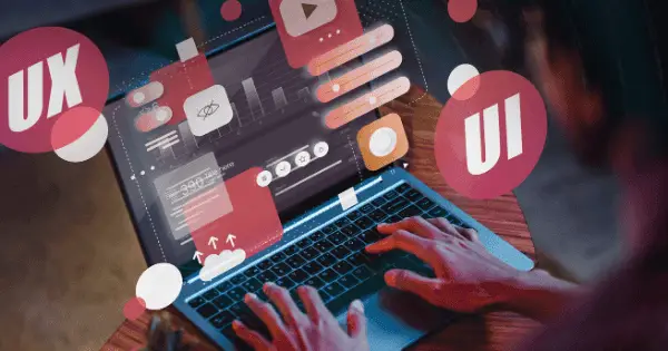 A QC Fixer designer focuses on corporate web design, enhancing UI/UX features on their laptop.